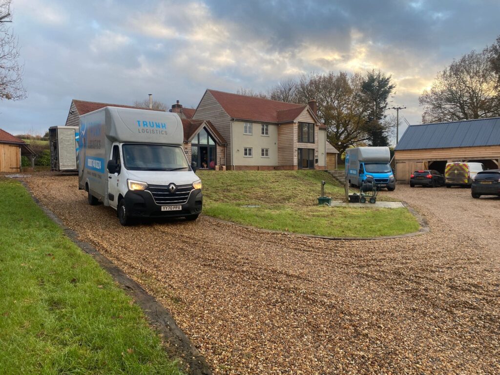 Multiple removals trucks outside large countryside property in Kent