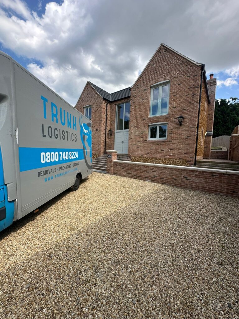 removals truck outside large house during home move