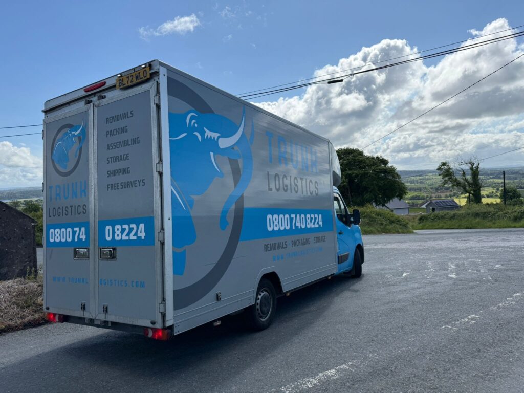 removals truck on countryside road during long distance move