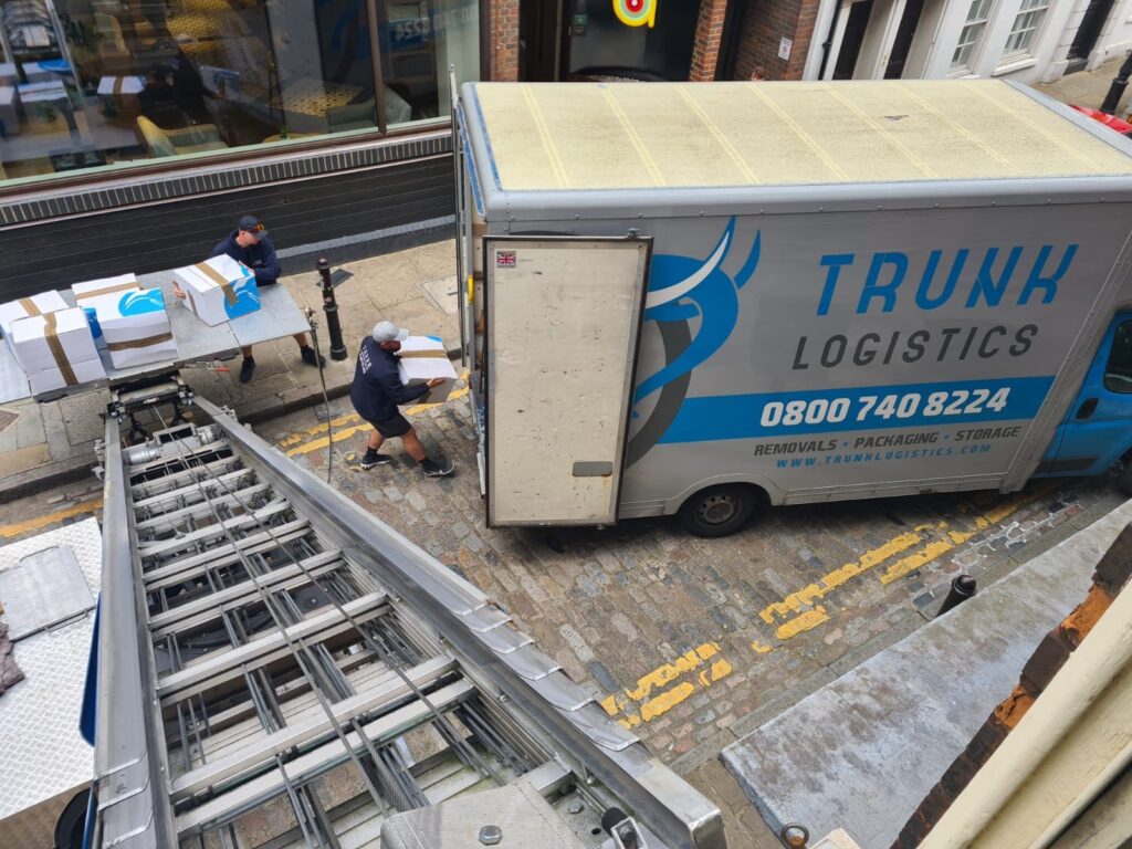 Removals crew using external lift system on London street