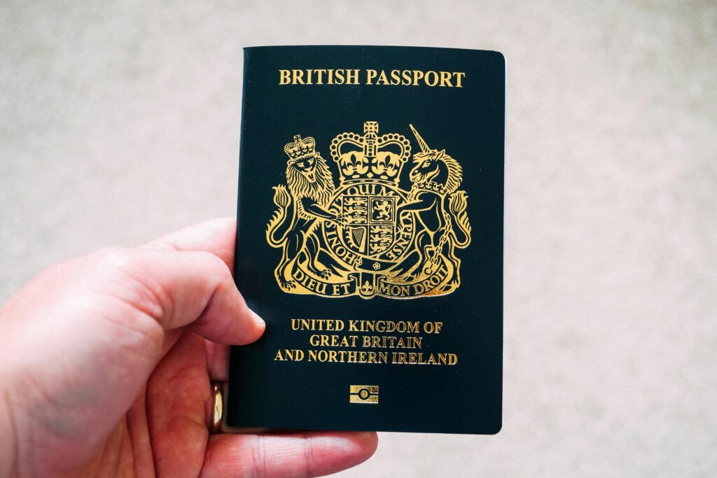 Hand holding a British passport — passport copy required for international moving customs clearance and personal effects duty-free entry