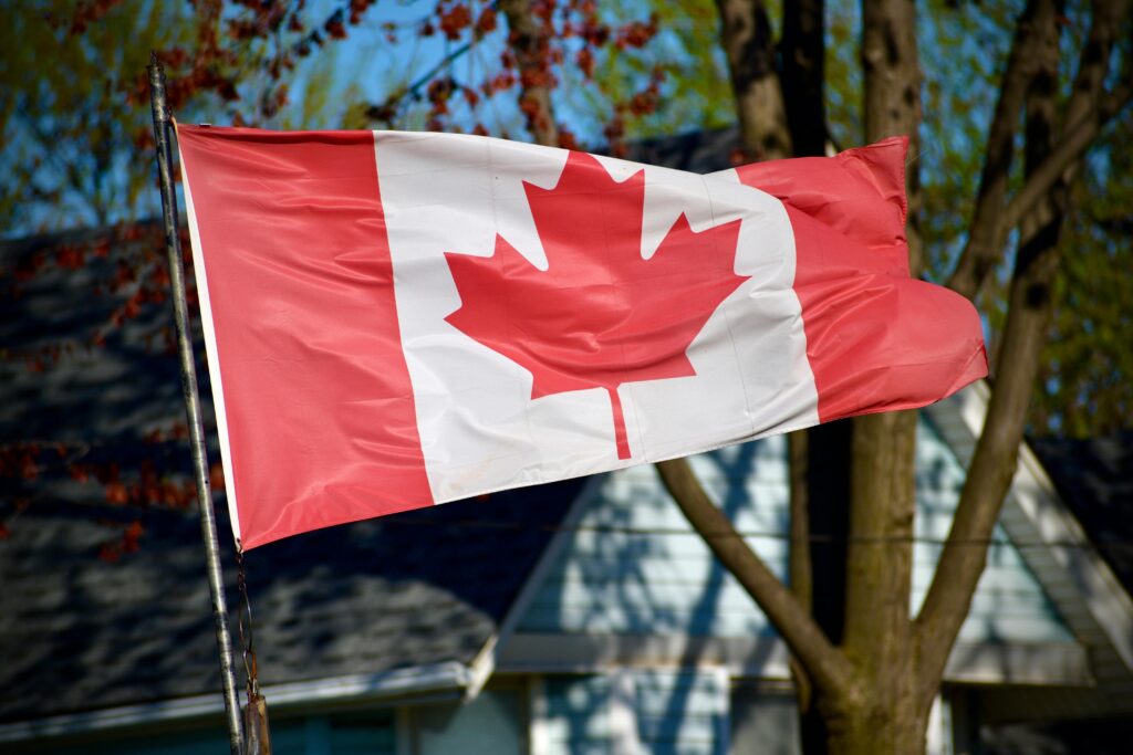 Canadian maple leaf flag flying outside a residential property — secondary destination image for Trunk Logistics UK to Canada removals guide