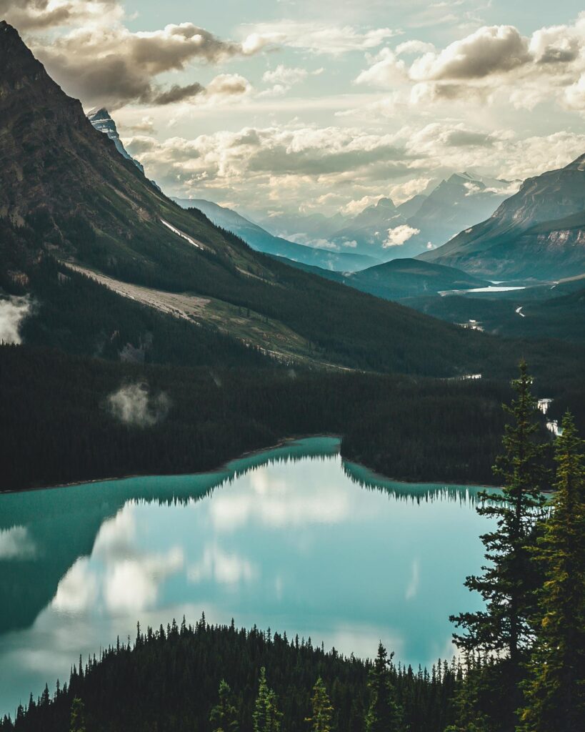 Turquoise glacial lake reflecting mountains and pine forest in the Canadian Rockies — destination image for Trunk Logistics UK to Canada international removals guide