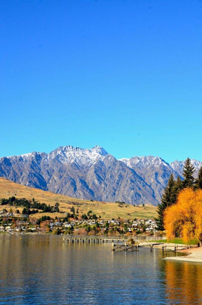 Queenstown New Zealand lakefront with the Remarkables mountain range in autumn — secondary destination image for Trunk Logistics UK to New Zealand removals guide