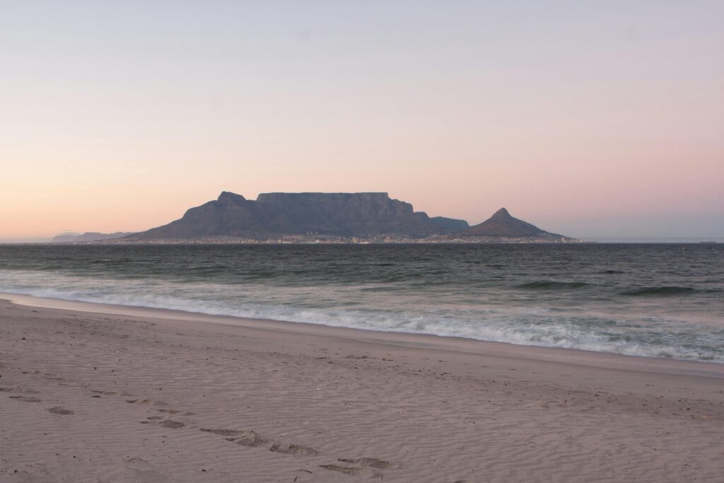 Table Mountain and Cape Town viewed across the Atlantic Ocean from Blouberg beach at dusk — secondary destination image for Trunk Logistics UK to South Africa removals guide