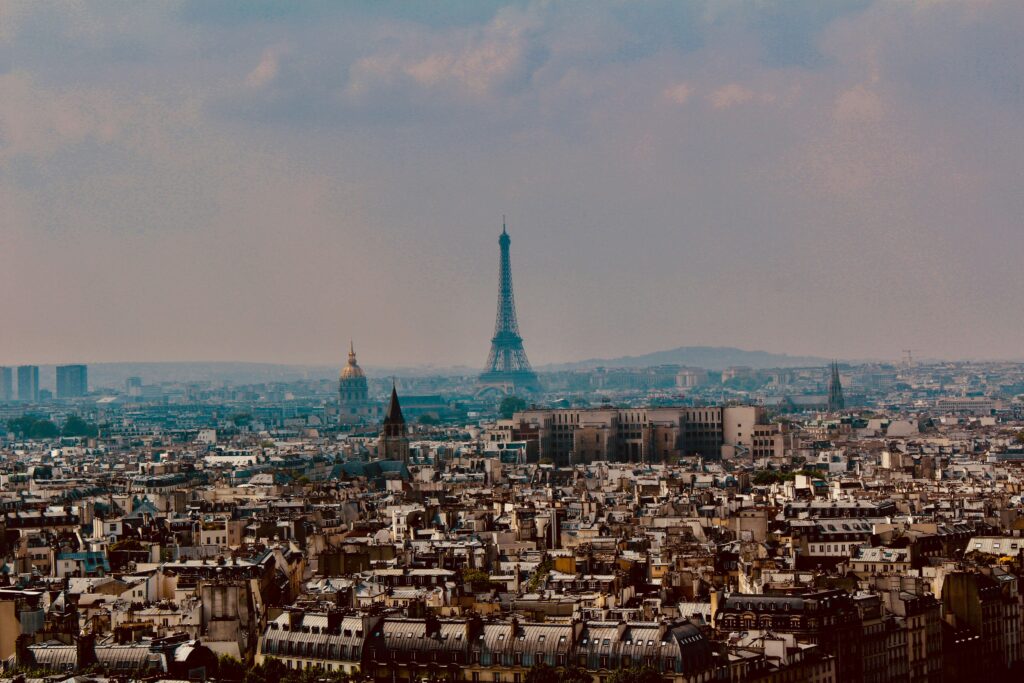 Aerial view of Paris cityscape at dusk showing the Eiffel Tower and Les Invalides — UK to France removals to Paris by Trunk Logistics
