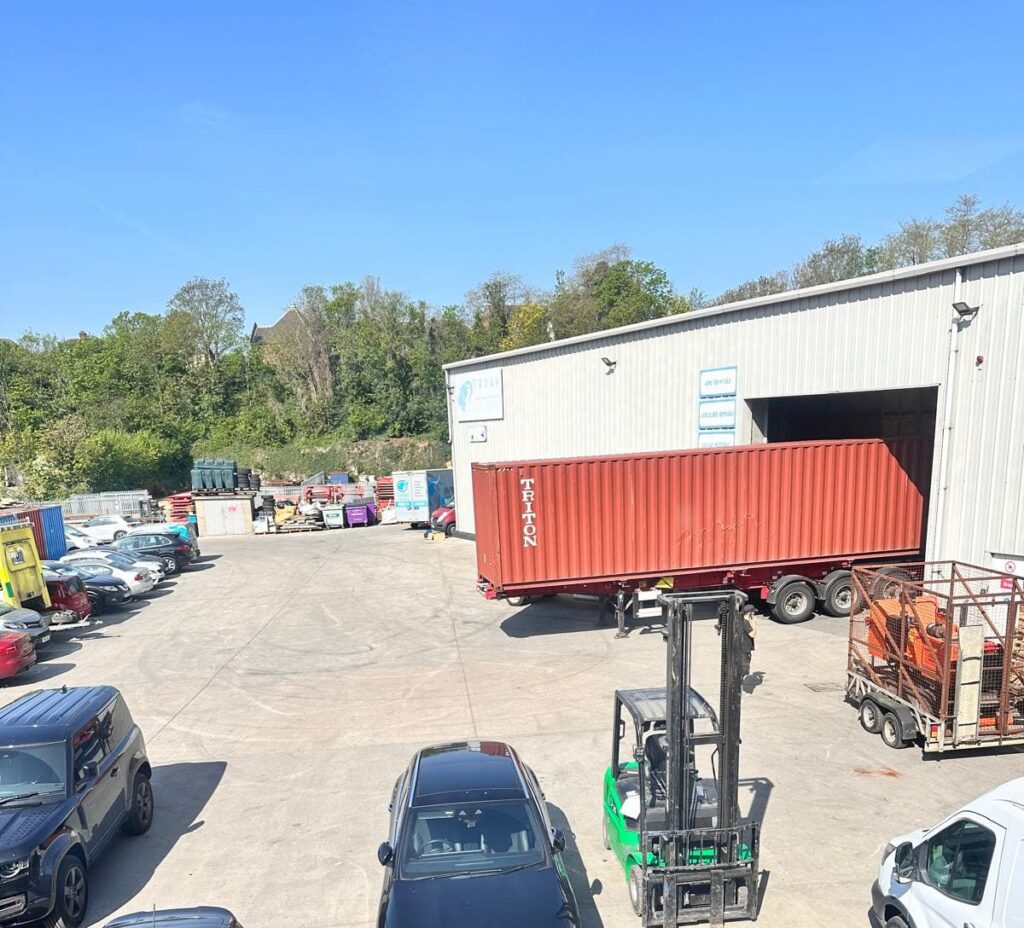 Trunk Logistics Essex depot with Triton shipping container being positioned by forklift for UK to USA sea freight removal
