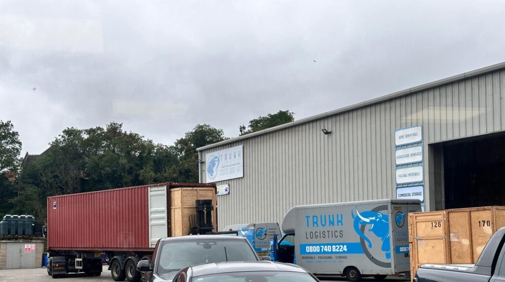 Trunk Logistics Essex depot with removal vans, shipping containers, and wooden storage crates being prepared for UK to South Africa international removals