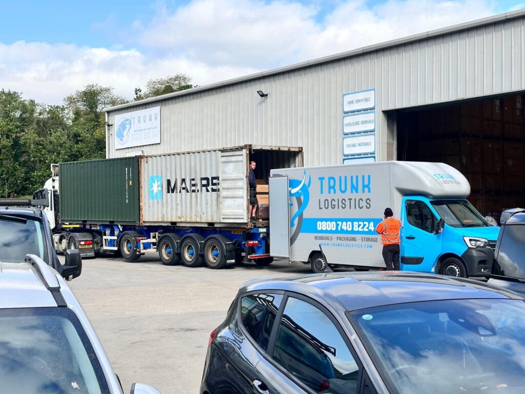 Trunk Logistics crew loading a Maersk shipping container at Essex depot alongside a branded removal van for UK to Canada sea freight removal
