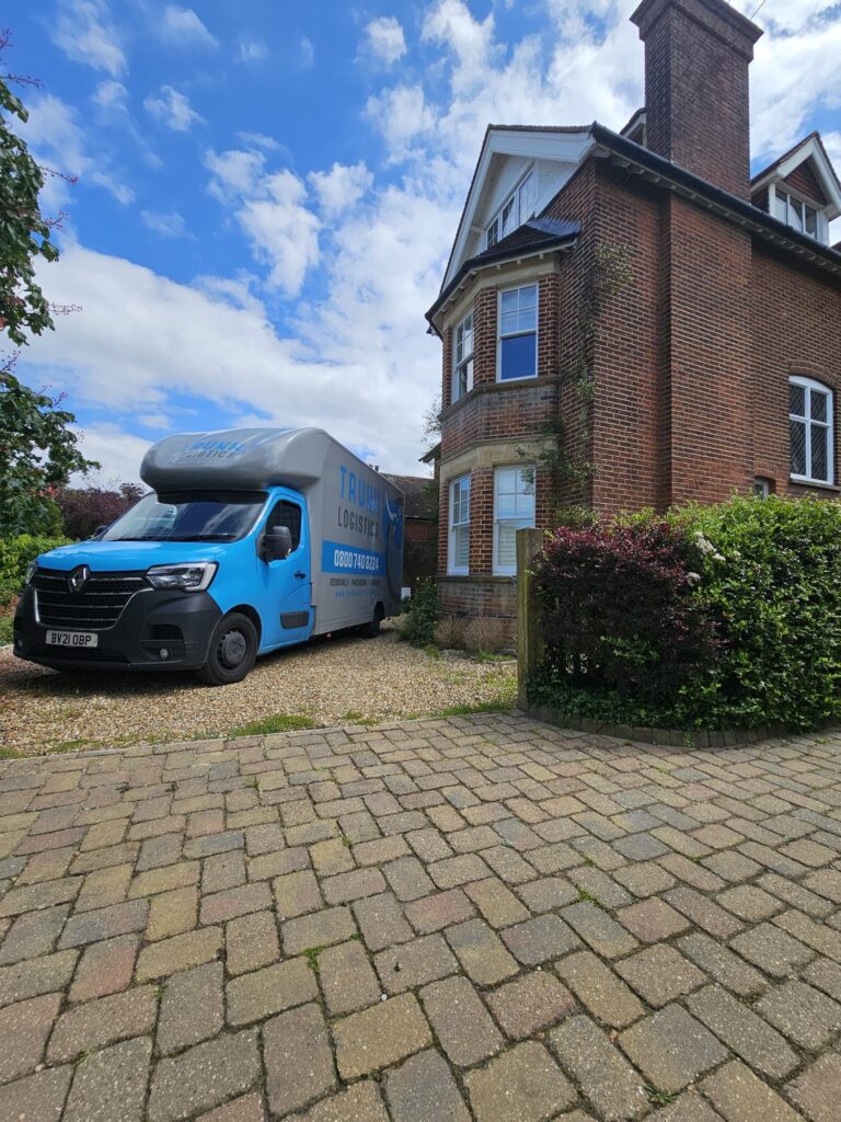 Trunk Logistics branded removal vehicle parked on the driveway of a period red-brick detached property — home removal survey and planning service