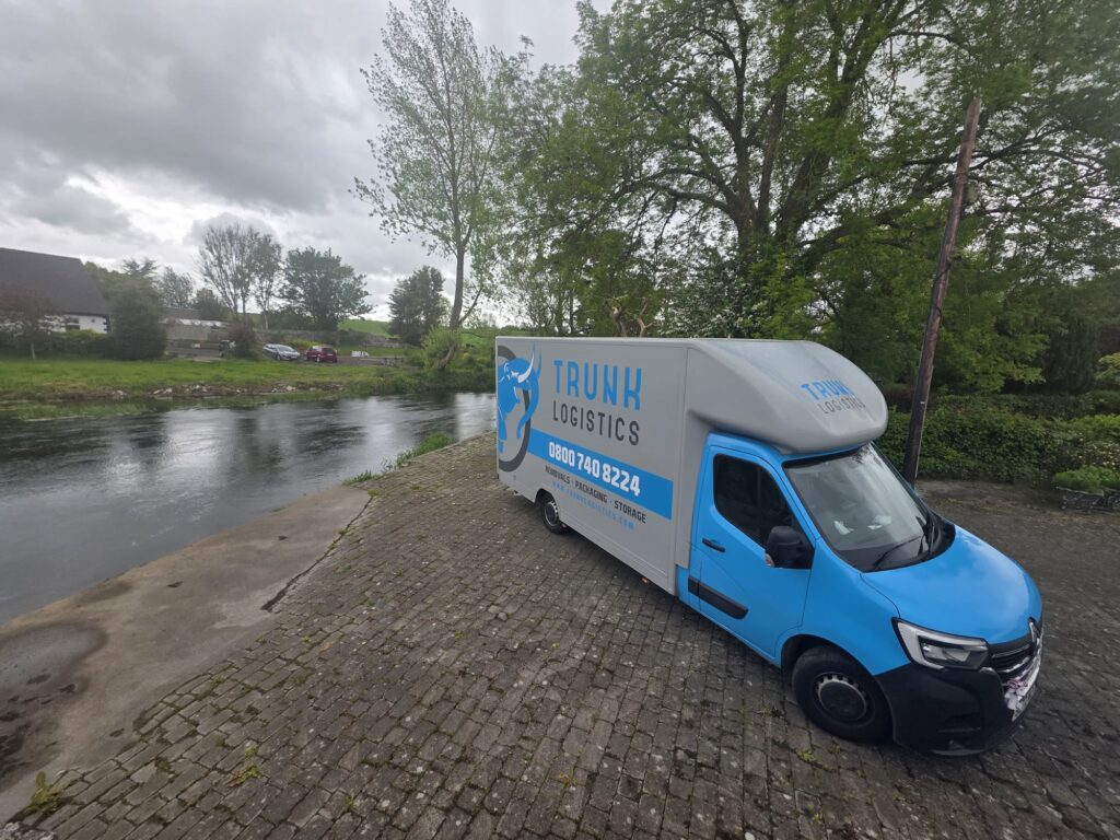 Waterford To UK Trunk Logistics removal van on a cobblestone riverside quay in County Tipperary — Ireland to UK removals collecting from County Tipperary and the south of Ireland