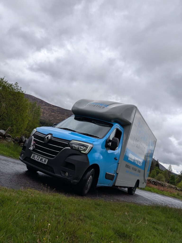 Trunk Logistics removal van on a narrow highland mountain road with dramatic moorland landscape — Ireland to UK removals service on the scenic route between Ireland and Great Britain