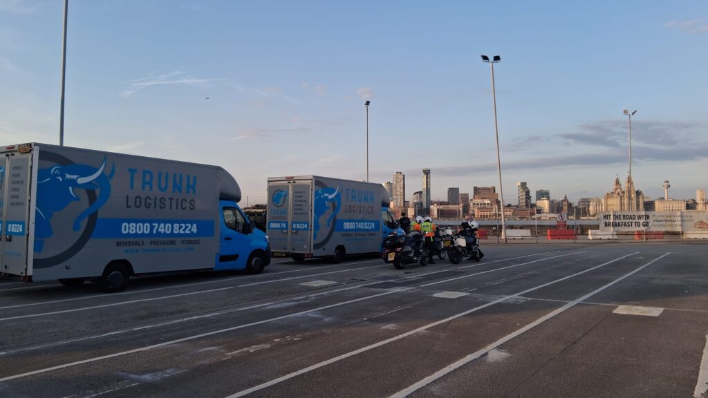 Two Trunk Logistics removal vans at Liverpool ferry port with the Royal Liver Building and Liverpool skyline in the background — Ireland to UK and UK to Ireland removals via the Liverpool to Belfast and Dublin ferry crossing