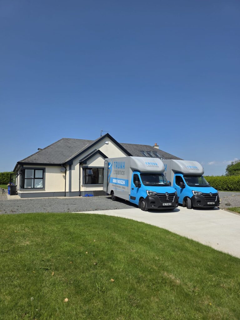 Kilkenny To UK Two Trunk Logistics removal vans on the driveway of a County Wexford property ready for collection — Ireland to UK removals from Wexford with dedicated vehicle and groupage options
